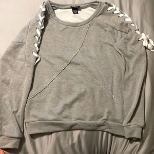 Rue 21 Size large, grey sweatshirt with laced arms.